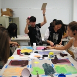 students doing printmaking with lots of color ink and action