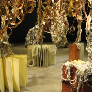 installation detail: books with draped yarn roots