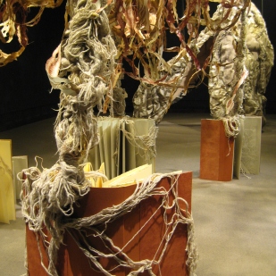 installation detail: books with draped yarn roots